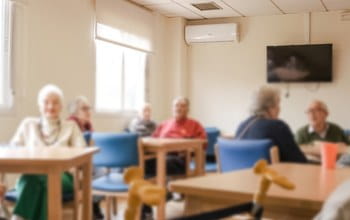 Wall-mounted air conditioning unit keeping a care home communal lounge at a comfortable temperature
